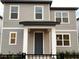 Modern two-story home with gray siding and dark door at 2407 Zuni Rd, St Cloud, FL 34771