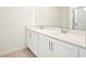 A bathroom with double vanity, quartz countertop, white cabinets and large mirror at 2437 Zuni Rd, St Cloud, FL 34771