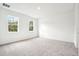 Spacious bedroom featuring neutral carpet and two windows overlooking the yard at 2437 Zuni Rd, St Cloud, FL 34771