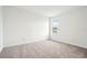 Clean, well-lit bedroom showcasing plush carpet, neutral walls, and natural light at 2437 Zuni Rd, St Cloud, FL 34771