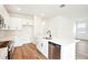 Bright kitchen boasts white cabinets, stainless steel appliances, and a center island with a sink at 2437 Zuni Rd, St Cloud, FL 34771