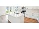 Modern kitchen featuring a central island, stainless steel appliances, and white cabinets for a clean, stylish look at 2437 Zuni Rd, St Cloud, FL 34771