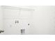 Simple yet functional laundry room with hookups and shelving for storage at 2437 Zuni Rd, St Cloud, FL 34771