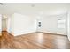 Bright and spacious living room featuring stylish wood flooring and freshly painted white walls at 2437 Zuni Rd, St Cloud, FL 34771