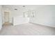 Cozy loft space with soft carpet, neutral walls, and natural lighting from surrounding windows at 2437 Zuni Rd, St Cloud, FL 34771