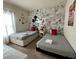 Bedroom with twin beds, Mickey Mouse theme, and ample natural light at 3208 Oyster Ln, Kissimmee, FL 34747