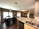 Dining area with dark wood table and bench seating, open to kitchen at 3208 Oyster Ln, Kissimmee, FL 34747