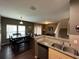 Dining area with dark wood table and bench seating, open to kitchen at 3208 Oyster Ln, Kissimmee, FL 34747