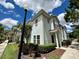 Two-story light blue townhome with landscaping and walkway at 3208 Oyster Ln, Kissimmee, FL 34747