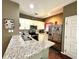 Galley kitchen with granite countertops and stainless steel appliances at 3208 Oyster Ln, Kissimmee, FL 34747