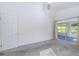 Spacious bedroom with grey carpet, sliding glass door to patio, and ceiling fan at 3667 Kingswood Ct, Clermont, FL 34711