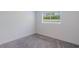 Simple bedroom with grey carpet and window at 3667 Kingswood Ct, Clermont, FL 34711