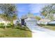 House exterior with gray paint, landscaping and driveway at 3667 Kingswood Ct, Clermont, FL 34711