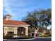 Gated community entrance with guardhouse and fountain at 3667 Kingswood Ct, Clermont, FL 34711