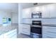 Modern kitchen with stainless steel appliances and granite countertops at 3667 Kingswood Ct, Clermont, FL 34711