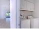 Laundry room with washer, dryer, and overhead cabinets at 3667 Kingswood Ct, Clermont, FL 34711