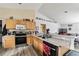 Kitchen with wood cabinets, granite countertop, and stainless steel appliances at 459 Abeno Ave, Deltona, FL 32725