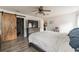 Main bedroom features a large bed and sliding barn door at 459 Abeno Ave, Deltona, FL 32725