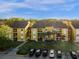 Aerial view of apartment buildings with parking and landscaping at 5271 Images Cir # 108, Kissimmee, FL 34746