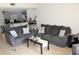 Living room with gray sofas, coffee table, and view of kitchen at 5271 Images Cir # 108, Kissimmee, FL 34746