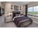A bedroom with a bed, guitar wall mounts, and a large window at 5296 Bowspirit Way, St Cloud, FL 34769