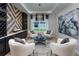 Sitting room with white chairs, a geometric rug, and wine storage at 5296 Bowspirit Way, St Cloud, FL 34769