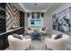 Sitting room with white chairs, a geometric rug, and wine storage at 5296 Bowspirit Way, St Cloud, FL 34769