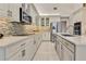 Modern kitchen with white cabinets, quartz countertops, and stainless steel appliances at 543 Timber Ridge Dr, Longwood, FL 32779