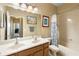 Well-lit bathroom with a double vanity and a shower/tub combo at 590 Michigan Estates Cir, St Cloud, FL 34769