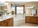 Elegant bathroom featuring double vanities, a large soaking tub, and a separate shower at 590 Michigan Estates Cir, St Cloud, FL 34769