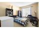 Charming bedroom with twin bed, built-in shelving, and workspace at 590 Michigan Estates Cir, St Cloud, FL 34769