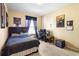 Cozy bedroom featuring a double bed, computer desk, and mini-fridge at 590 Michigan Estates Cir, St Cloud, FL 34769
