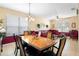 Bright dining room features a wood table and six chairs, adjacent to a living area at 590 Michigan Estates Cir, St Cloud, FL 34769