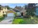 Attractive single-story house with a two-car garage and landscaped yard at 590 Michigan Estates Cir, St Cloud, FL 34769