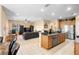 Open kitchen with an island, granite countertops, and stainless steel appliances at 590 Michigan Estates Cir, St Cloud, FL 34769
