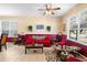 Comfortable living room with red sofa and two accent chairs at 590 Michigan Estates Cir, St Cloud, FL 34769