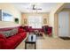 Cozy living room featuring a red sofa and a coffee table at 590 Michigan Estates Cir, St Cloud, FL 34769
