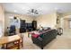 Relaxing living room with black leather sofas and a large flat screen TV at 590 Michigan Estates Cir, St Cloud, FL 34769