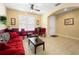 Living room with red sofa and coffee table, featuring a neutral color scheme at 590 Michigan Estates Cir, St Cloud, FL 34769