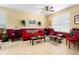 Living room with red sofa and coffee table, featuring a neutral color scheme at 590 Michigan Estates Cir, St Cloud, FL 34769