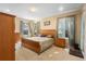 Large main bedroom with wood furniture, neutral decor, and plenty of natural light at 590 Michigan Estates Cir, St Cloud, FL 34769