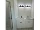 Double vanity bathroom with quartz countertop and modern fixtures at 702 Marion Oaks Manor, Ocala, FL 34473