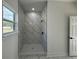 Spa-like shower with marble tile and modern fixtures at 702 Marion Oaks Manor, Ocala, FL 34473