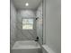 Modern bathroom with marble tile and a new bathtub at 702 Marion Oaks Manor, Ocala, FL 34473