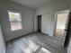 Well-lit bedroom featuring wood-look floors and ample closet space at 702 Marion Oaks Manor, Ocala, FL 34473