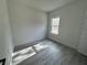 Bright bedroom with wood-look floors and a large window at 702 Marion Oaks Manor, Ocala, FL 34473