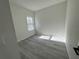 Simple bedroom with wood-look floors and a window at 702 Marion Oaks Manor, Ocala, FL 34473