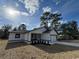 New construction home featuring a white exterior, black accents, and a two-car garage at 702 Marion Oaks Manor, Ocala, FL 34473