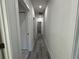 Long hallway with wood-look floors and access to multiple rooms at 702 Marion Oaks Manor, Ocala, FL 34473