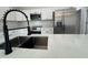 Modern kitchen with white cabinets, stainless steel appliances, and quartz countertops at 702 Marion Oaks Manor, Ocala, FL 34473